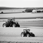Line art of a farm tractor plowing a field with a barn in the background, designed as a black and white coloring book page with no shading.